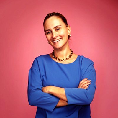 Dr Nara Daubeney smiling, wearing a blue top